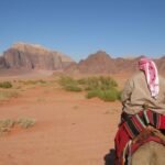Traveler Riding a Camel in a Saudi Arabian Desert